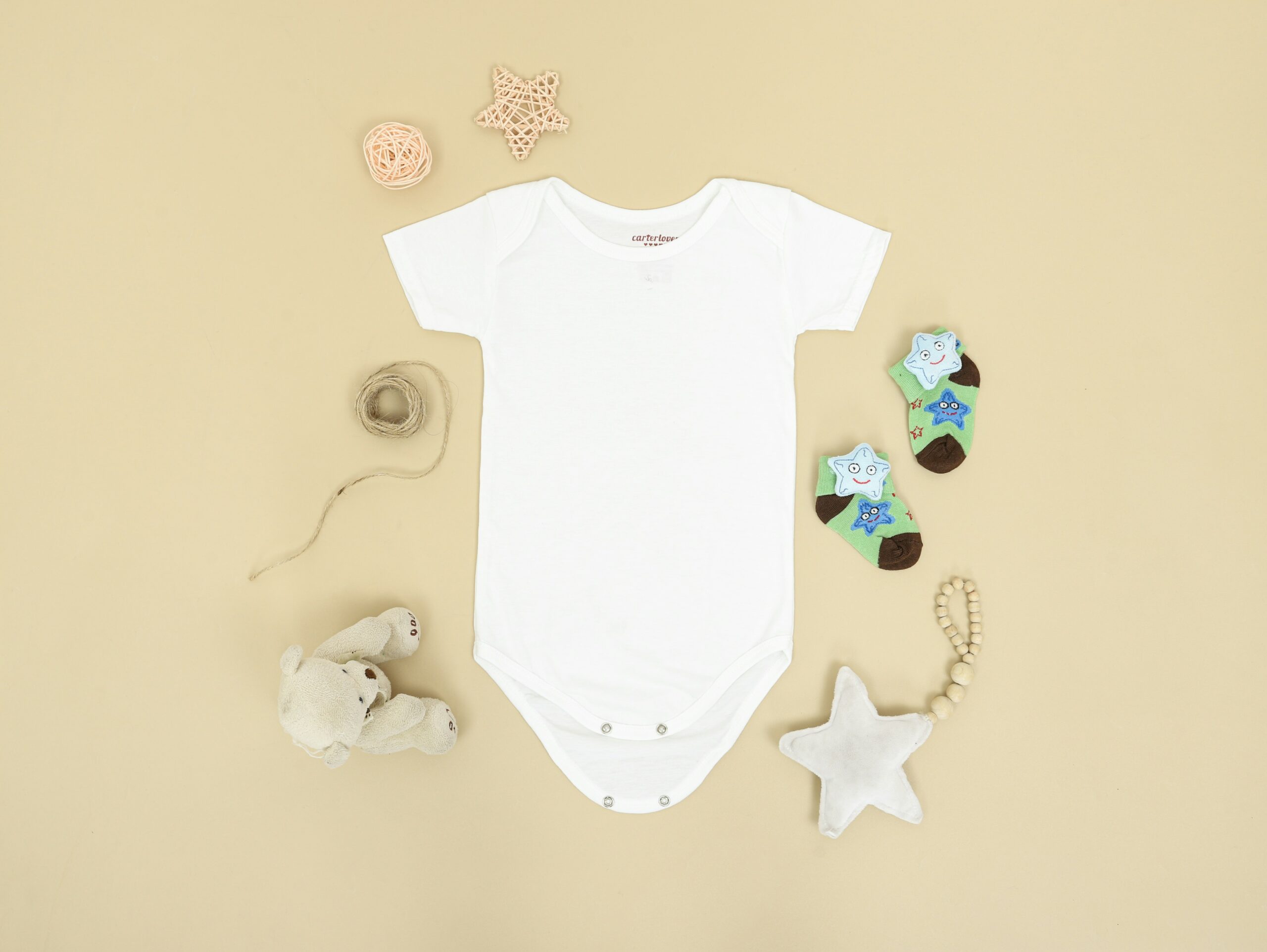 White baby onesie and other baby items