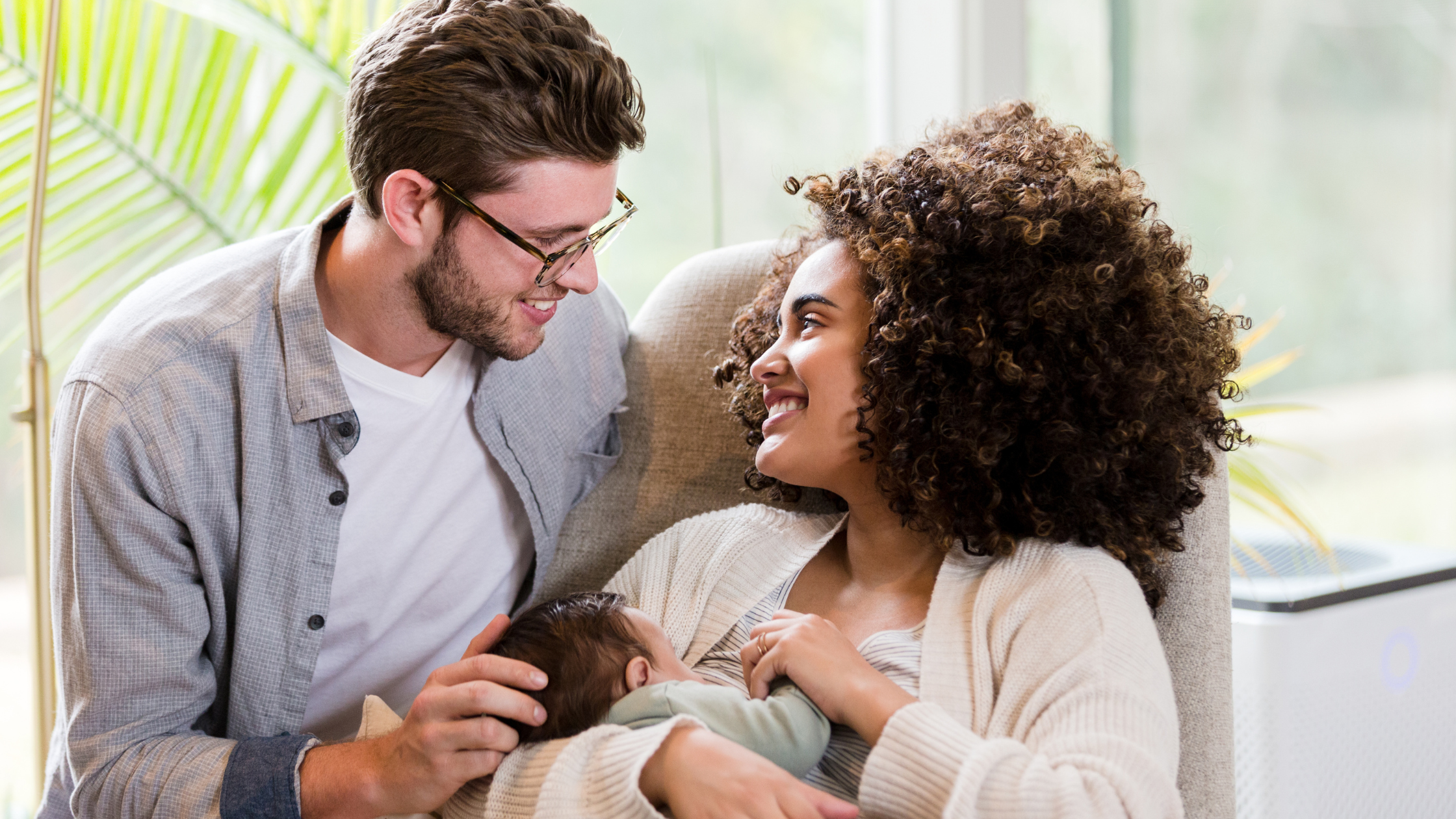 new parents holding baby: your partner can help you postpartum